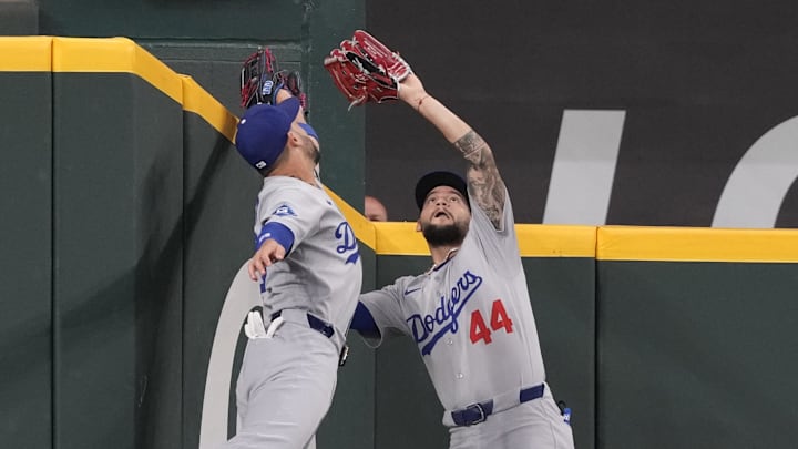 Apr 19, 2025; Arlington, Texas, USA; Los Angeles Dodgers center fielder Andy Pages (44) and left fielder Michael Conforto (23) leap for the fly-out hit by Texas Rangers shortstop Corey Seager (not shown) during the first inning at Globe Life Field. Pages made the catch.