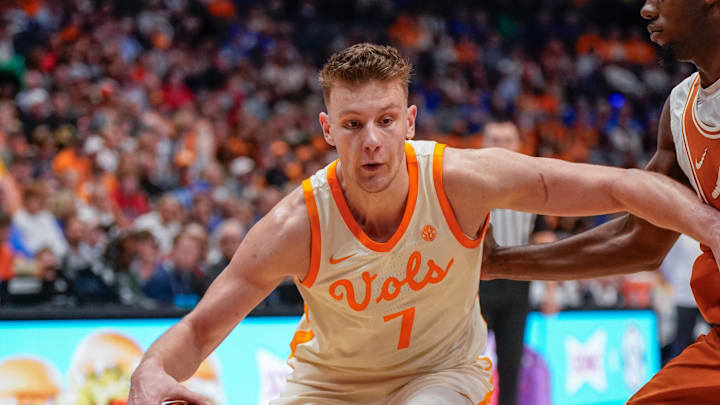 Tennessee forward Igor Milicic Jr. (7) dribbles around a Texas defender during the first half of a Southeastern Conference tournament quarterfinal game at Bridgestone Arena in Nashville, Tenn., Friday, March 14, 2025.