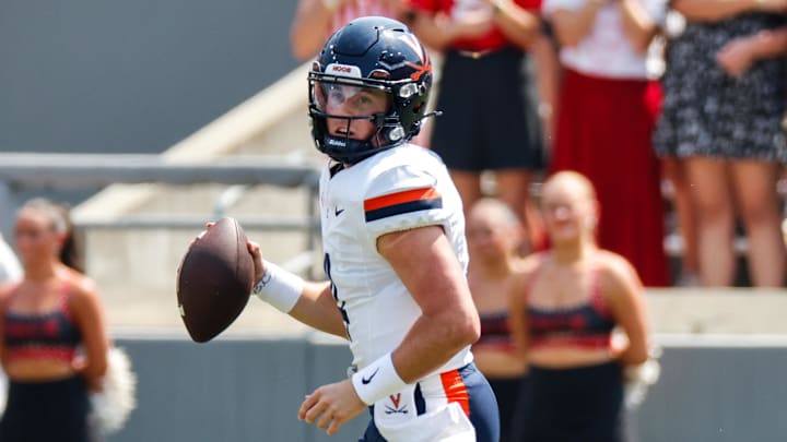 Sep 6, 2025; Raleigh, North Carolina, USA; Virginia Cavaliers quarterback Chandler Morris (4) runs with the football during the first half of the game against North Carolina State Wolfpack at Carter-Finley Stadium. Mandatory Credit: Jaylynn Nash-Imagn Images Sep 6, 2025; Raleigh, North Carolina, USA; Virginia Cavaliers quarterback Chandler Morris (4) runs with the football during the first half of the game against North Carolina State Wolfpack at Carter-Finley Stadium. Mandatory Credit: Jaylynn Nash-Imagn Images