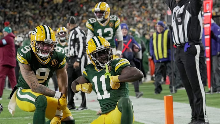 Green Bay Packers wide receiver Jayden Reed (11) celebrates his touchdown reception with wide receiver Christian Watson (9) during the second quarter of their game against the Miami Dolphins Thursday, November 28, 2024 at Lambeau Field in Green Bay, Wisconsin.