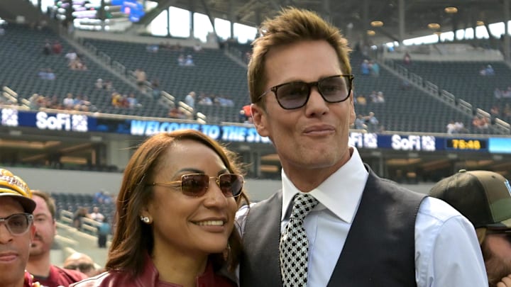 Oct 5, 2025; Inglewood, California, USA;  Regina Jackson, mother of Washington Commanders quarterback Jayden Daniels (5) takes a photo with former NFL quarterback Tom Brady, lead game analyst with FOX, prior to the game against the Los Angeles Chargers at SoFi Stadium. Mandatory Credit: Jayne Kamin-Oncea-Imagn Images