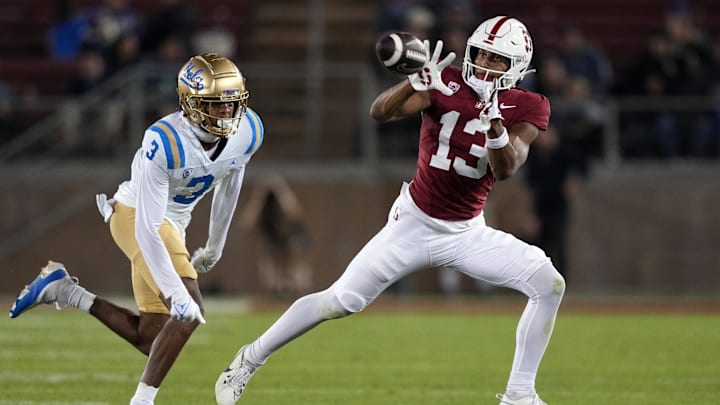 Oct 21, 2023; Stanford, California, USA; Stanford Cardinal wide receiver Elic Ayomanor (13) catches a pass against UCLA Bruins defensive back Devin Kirkwood (3) during the fourth quarter at Stanford Stadium. Mandatory Credit: Darren Yamashita-Imagn Images