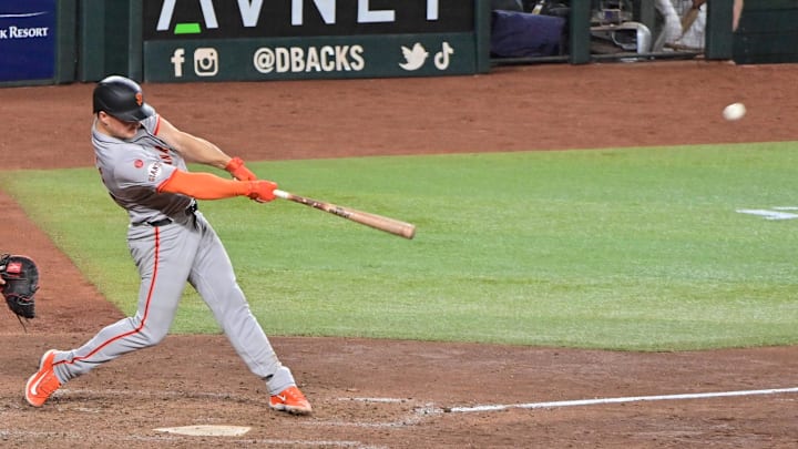 Sep 23, 2024; Phoenix, Arizona, USA;  San Francisco Giants third base Matt Chapman (26) hits a RBI triple in the seventh inning against the Arizona Diamondbacks at Chase Field.