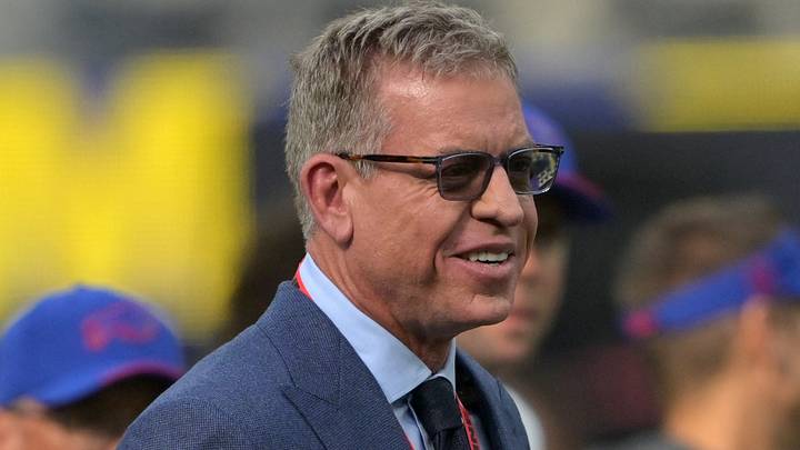 Former NFL QB Troy Aikman looks on from the field prior to the game between the Los Angeles Rams and the Buffalo Bills. Former NFL QB Troy Aikman looks on from the field prior to the game between the Los Angeles Rams and the Buffalo Bills.