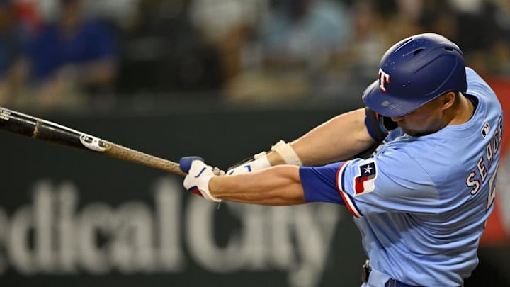 Texas Rangers shortstop Corey Seager (5) hits a single during the third inning against the Cleveland Guardians at Globe Life Field. 