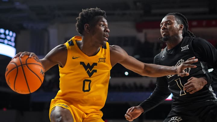 Feb 5, 2026; Cincinnati, Ohio, USA; West Virginia Mountaineers forward Brenen Lorient (0) dribbles the ball against Cincinnati Bearcats guard Day Day Thomas (1) in the second half at Fifth Third Arena. Mandatory Credit: Aaron Doster-Imagn Images Feb 5, 2026; Cincinnati, Ohio, USA; West Virginia Mountaineers forward Brenen Lorient (0) dribbles the ball against Cincinnati Bearcats guard Day Day Thomas (1) in the second half at Fifth Third Arena. Mandatory Credit: Aaron Doster-Imagn Images