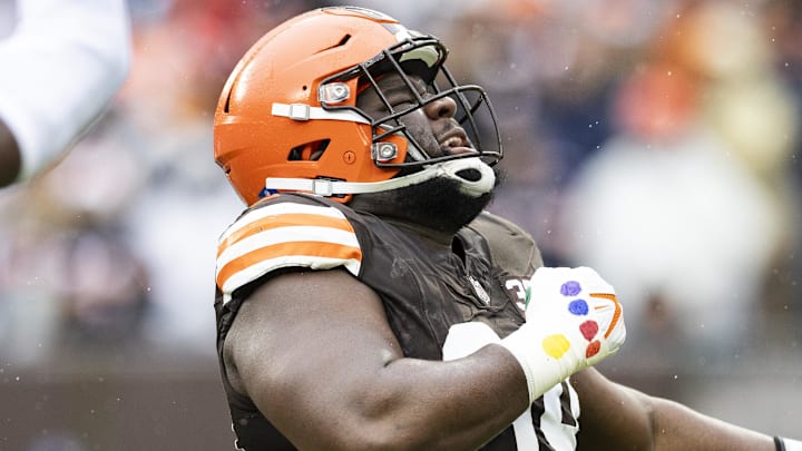 Dec 17, 2023; Cleveland, Ohio, USA; Cleveland Browns defensive tackle Dalvin Tomlinson (94) celebrates a tackle for loss against the Chicago Bears during the first quarter at Cleveland Browns Stadium. Mandatory Credit: Scott Galvin-Imagn Images