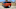 Rear three quarter of a 2025 Hyundai Santa Fe Calligraphy AWD in Terracotta Orange. Rear three quarter of a 2025 Hyundai Santa Fe Calligraphy AWD in Terracotta Orange.