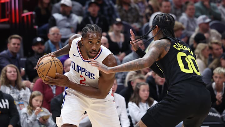 Oct 27, 2023; Salt Lake City, Utah, USA; Los Angeles Clippers forward Kawhi Leonard (2) looks to drive the ball against Utah Jazz guard Jordan Clarkson (00) in the second quarter at Delta Center. Mandatory Credit: Rob Gray-Imagn Images