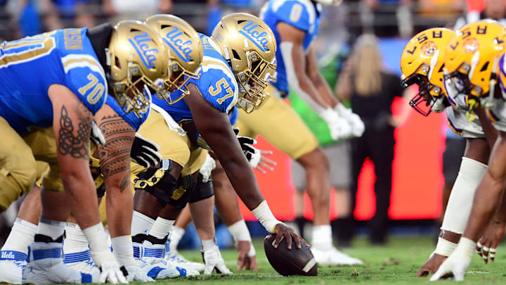 Sep 4, 2021; Pasadena, California, USA; UCLA Bruins offensive lineman Jon Gaines II (57) lines up against the Louisiana State Tigers defense during the first half the at the Rose Bowl. Mandatory Credit: Gary A. Vasquez-Imagn Images