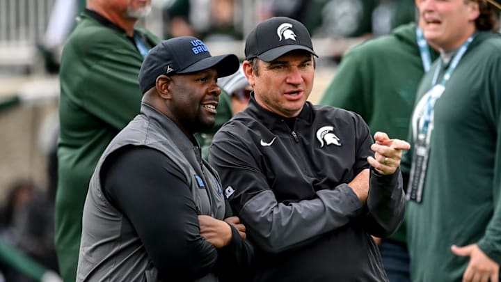 Michigan State's head coach Jonathan Smith, right, talks with UCLA's interim head coach Tim Skipper before the football game on Saturday, Oct. 11, 2025, at Spartan Stadium in East Lansing.