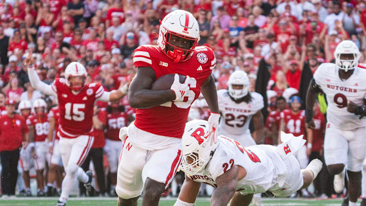Oct 5, 2024; Lincoln, Nebraska, USA; Nebraska Cornhuskers wide receiver Janiran Bonner (16) runs for a touchdown against Rutgers Scarlet Knights linebacker Tyreem Powell (22) during the second quarter at Memorial Stadium.