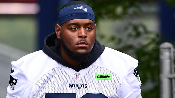 New England Patriots offensive tackle Vederian Lowe (59) walks to the practice field during training camp at Gillette Stadium.