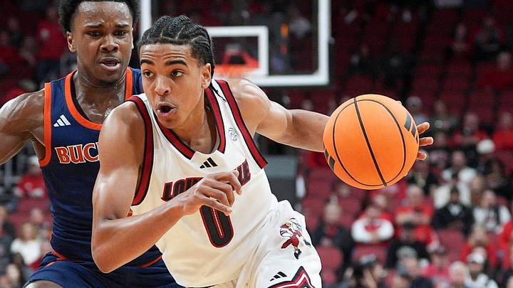 Louisville Cardinals guard Mikel Brown Jr. (0) drives by Bucknell Bison guard Jayden Williams (2) during an exhibition game at the KFC Yum! Center in Louisville, Kentucky Tuesday October 28, 2025. Louisville Cardinals guard Mikel Brown Jr. (0) drives by Bucknell Bison guard Jayden Williams (2) during an exhibition game at the KFC Yum! Center in Louisville, Kentucky Tuesday October 28, 2025.