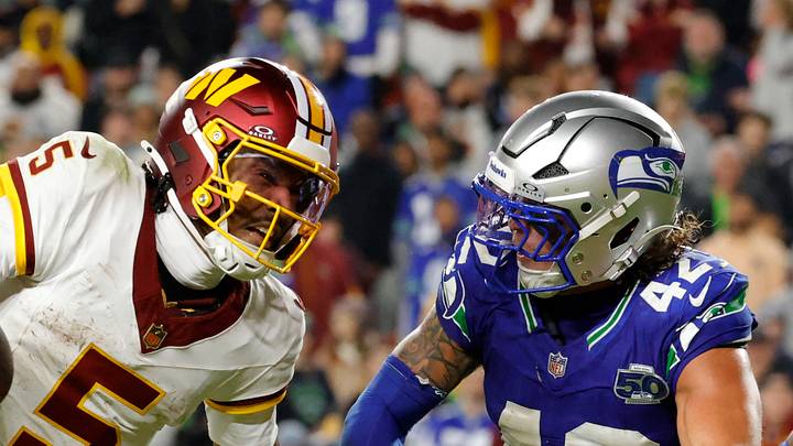 Washington Commanders quarterback Jayden Daniels runs the ball defended by Seattle Seahawks linebacker Drake Thomas. Washington Commanders quarterback Jayden Daniels runs the ball defended by Seattle Seahawks linebacker Drake Thomas.