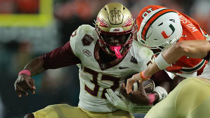 Oct 17, 2026; Miami Gardens, Florida, USA; Florida State Seminoles running back Ousmane Kromah (32) runs against Miami Hurricanes defensive line Damon Wilson II (10) during the first quarter at Hard Rock Stadium. Mandatory Credit: Sam Navarro-Imagn Images Oct 17, 2026; Miami Gardens, Florida, USA; Florida State Seminoles running back Ousmane Kromah (32) runs against Miami Hurricanes defensive line Damon Wilson II (10) during the first quarter at Hard Rock Stadium. Mandatory Credit: Sam Navarro-Imagn Images