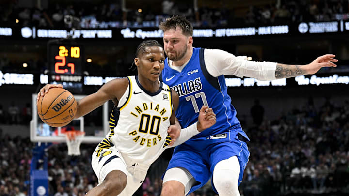 Mar 5, 2024; Dallas, Texas, USA; Indiana Pacers guard Bennedict Mathurin (00) brings the ball up court past Dallas Mavericks guard Luka Doncic (77) during the second half at the American Airlines Center. Mandatory Credit: Jerome Miron-Imagn Images Mar 5, 2024; Dallas, Texas, USA; Indiana Pacers guard Bennedict Mathurin (00) brings the ball up court past Dallas Mavericks guard Luka Doncic (77) during the second half at the American Airlines Center. Mandatory Credit: Jerome Miron-Imagn Images