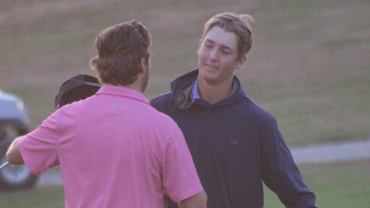 Ferris State University teammates Caleb Bond (right) and Shayne Beaufait embrace following the second playoff hole in the Northern Michigan Open on Sunday night. Ferris State University teammates Caleb Bond (right) and Shayne Beaufait embrace following the second playoff hole in the Northern Michigan Open on Sunday night.