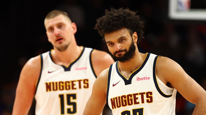 Nov 29, 2025; Phoenix, Arizona, USA; Denver Nuggets guard Jamal Murray (27) and center Nikola Jokic (15) against the Phoenix Suns at the Mortgage Matchup Center. Mandatory Credit: Mark J. Rebilas-Imagn Images