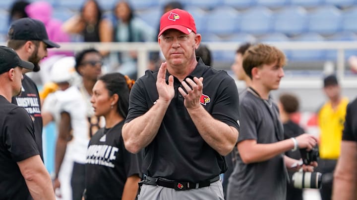 Dec 23, 2025; Boca Raton, FL, USA; Louisville Cardinals head coach Jeff Brohm watches his team warm up before the Boca Raton Bowl against the Toledo Rockets at Flagler CU Stadium. Mandatory Credit: Jeff Romance-Imagn Images