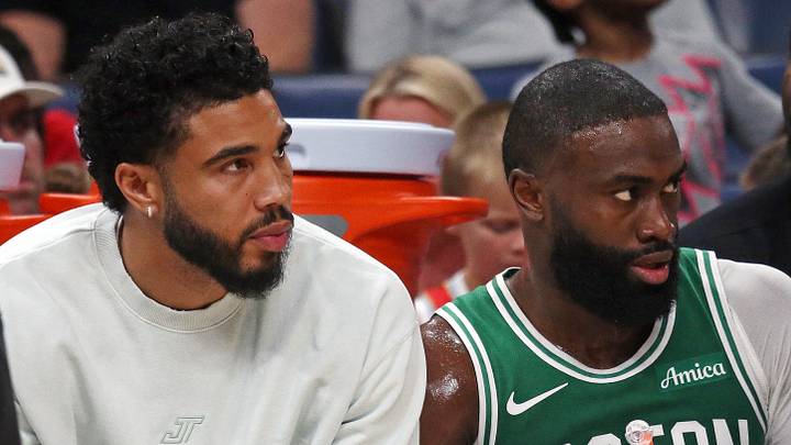 Oct 8, 2025; Memphis, Tennessee, USA; Boston Celtics forward Jayson Tatum (0) and guard Jaylen Brown (7) look on from the bench during the second quarter against the Memphis Grizzlies at FedExForum. Mandatory Credit: Petre Thomas-Imagn Images