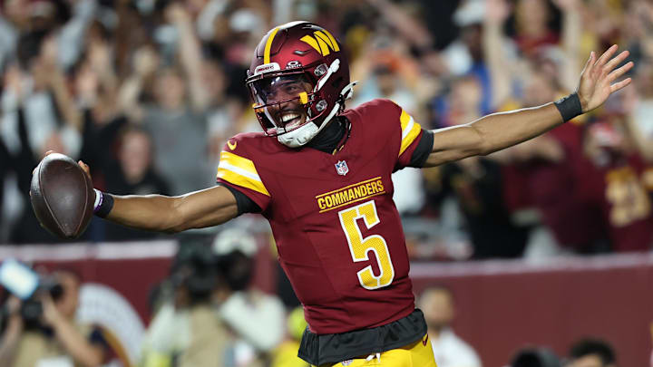 Aug 18, 2025; Landover, Maryland, USA; Washington Commanders quarterback Jayden Daniels (5) celebrates after scoring a touchdown against Cincinnati Bengals during the first half at Northwest Stadium. Mandatory Credit: Amber Searls-Imagn Images