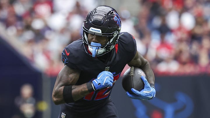 Oct 6, 2024; Houston, Texas, USA; Houston Texans wide receiver Nico Collins (12) runs with the ball after a reception during the first quarter against the Buffalo Bills at NRG Stadium. Mandatory Credit: Troy Taormina-Imagn Images