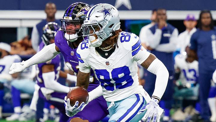 Dallas Cowboys wide receiver CeeDee Lamb runs with ball being pursued by Baltimore Ravens linebacker Trenton Simpson.