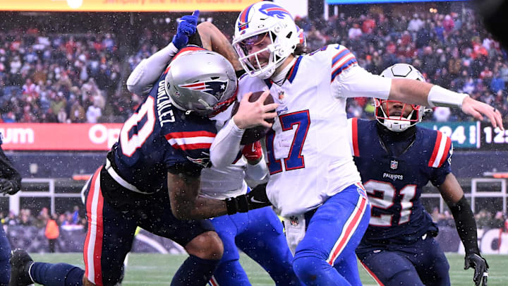 New England Patriots cornerback Christian Gonzalez pushes Buffalo Bills quarterback Josh Allen out of bounds.