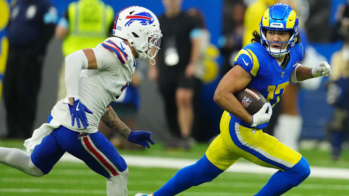 Dec 8, 2024; Inglewood, California, USA; Los Angeles Rams wide receiver Puka Nacua (17) carries the ball against Buffalo Bills cornerback Taron Johnson (7) in the second half at SoFi Stadium. Mandatory Credit: Kirby Lee-Imagn Images