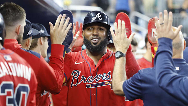Jun 21, 2025; Miami, Florida, USA;  Atlanta Braves designated hitter Marcell Ozuna (20) is congratulated in the dugout after scoring on a home run by teammate catcher Drake Baldwin (30) against the Miami Marlins during the ninth inning at loanDepot Park. Mandatory Credit: Rhona Wise-Imagn Images