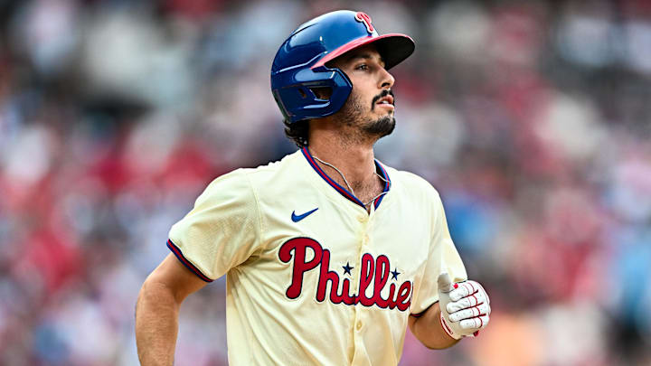 Jun 5, 2024; Philadelphia, Pennsylvania, USA; Philadelphia Phillies catcher Garrett Stubbs (21) advances to first on a walk against the Milwaukee Brewers in the fifth inning at Citizens Bank Park