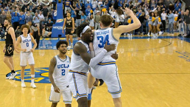 Jan 20, 2026; Los Angeles, California, USA; UCLA Bruins guard Eric Dailey Jr. (3) and forward guard Donovan Dent (2) celebrate after a 3-point basket by forward Tyler Bilodeau (34) in the final seconds of the game against the Purdue Boilermakers at Pauley Pavilion presented by Wescom Financial. Mandatory Credit: Jayne Kamin-Oncea-Imagn Images