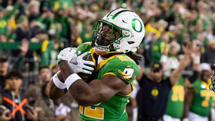Oregon running back Jay Harris carries the ball for a touchdown as Minnesota defensive back Jai'Onte' McMillan pursues as the Oregon Ducks host the Minnesota Golden Gophers on Nov. 14, 2025, at Autzen Stadium in Eugene, Oregon.