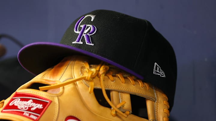 Jun 15, 2023; Atlanta, Georgia, USA; A detailed view of a Colorado Rockies hat and glove on the bench against the Atlanta Braves in the ninth inning at Truist Park. Mandatory Credit: Brett Davis-Imagn Images