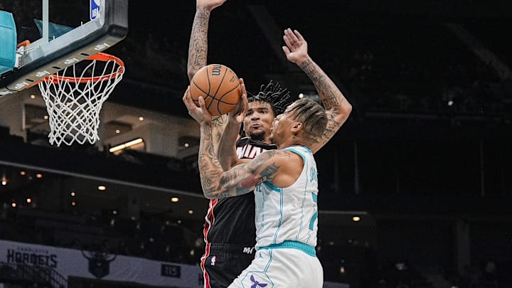 Oct 8, 2024; Charlotte, North Carolina, USA; Charlotte Hornets forward Keyontae Johnson (7) takes a shot against by Miami Heat center Kel'el Ware (7) during the second half at Spectrum Center. Mandatory Credit: Jim Dedmon-Imagn Images Oct 8, 2024; Charlotte, North Carolina, USA; Charlotte Hornets forward Keyontae Johnson (7) takes a shot against by Miami Heat center Kel'el Ware (7) during the second half at Spectrum Center. Mandatory Credit: Jim Dedmon-Imagn Images