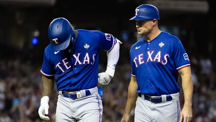 Oct 30, 2023; Phoenix, AZ, USA; Texas Rangers right fielder Adolis Garcia (left) reacts alongside first base coach Corey Ragsdale after after suffering an injury in the eighth inning of game three of the 2023 World Series against the Arizona Diamondbacks at Chase Field. 