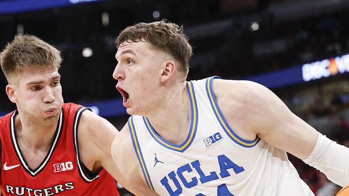 Mar 12, 2026; Chicago, IL, USA; UCLA Bruins forward Tyler Bilodeau (34) drives to the basket against Rutgers Scarlet Knights guard Harun Zrno (13) during the second half at United Center. Mandatory Credit: Kamil Krzaczynski-Imagn Images