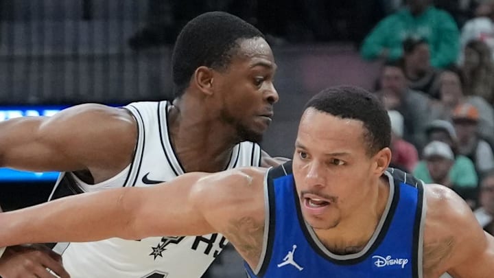 Orlando Magic guard Desmond Bane dribbles past San Antonio Spurs guard De'Aaron Fox.
