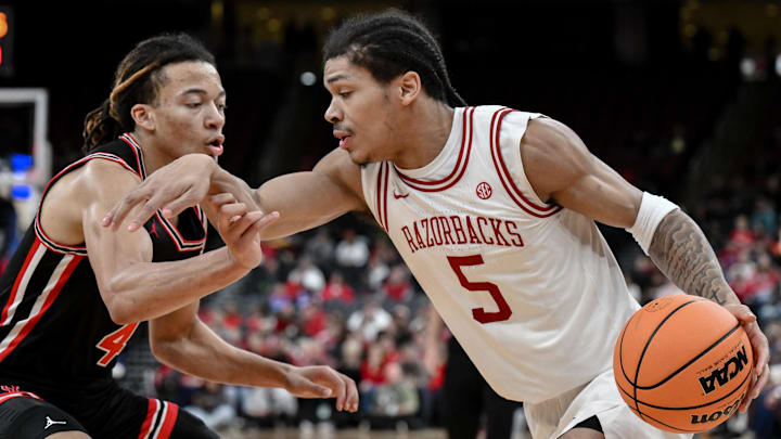 Arkansas Razorbacks guard Darius Acuff Jr. (5) tries to drive past Houston Cougars guard Kingston Flemings (4) during the first half at Prudential Center.