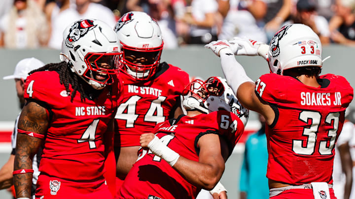 Oct 4, 2025; Raleigh, North Carolina, USA; NC State Wolfpack defensive end Sabastian Harsh (54) and linebacker Jr. Kenny Soares (33) celebrate a tackle during the first half of the game against Campbell Fighting Camels at Carter-Finley Stadium. Mandatory Credit: Jaylynn Nash-Imagn Images Oct 4, 2025; Raleigh, North Carolina, USA; NC State Wolfpack defensive end Sabastian Harsh (54) and linebacker Jr. Kenny Soares (33) celebrate a tackle during the first half of the game against Campbell Fighting Camels at Carter-Finley Stadium. Mandatory Credit: Jaylynn Nash-Imagn Images