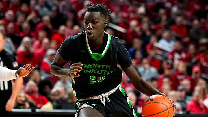 Dec 20, 2023; Lincoln, Nebraska, USA; North Dakota Fighting Hawks forward B.J. Omot (20) drives against Nebraska Cornhuskers forward Juwan Gary (4) during the second half at Pinnacle Bank Arena. 