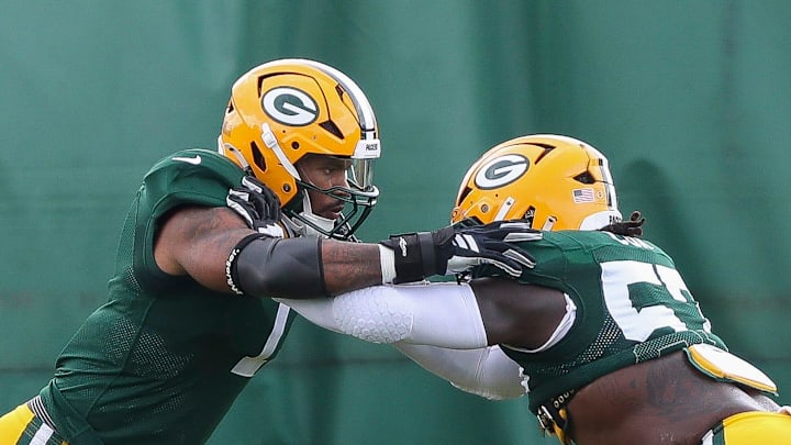 Green Bay Packers defensive ends Micah Parsons (1) and Brenton Cox Jr. (57)
