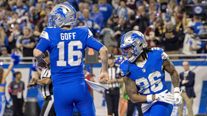 Detroit Lions running back Jahmyr Gibbs (26) celebrates a touchdown with quarterback Jared Goff (16).
