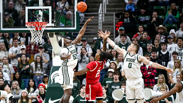 Michigan State's Coen Carr, left, blocks a shot by Nebraska's Ahron Ulis during the first half. Michigan State's Coen Carr, left, blocks a shot by Nebraska's Ahron Ulis during the first half.