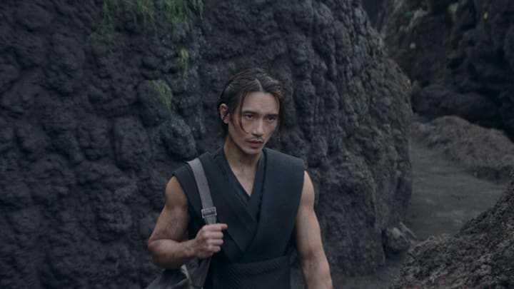 The Stranger (Manny Jacinto) in Lucasfilm's THE ACOLYTE, season one, exclusively on Disney+. ©2024 Lucasfilm Ltd. & TM. All Rights Reserved.