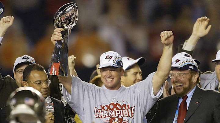 Jan 26, 2003; San Diego, CA, USA; FILE PHOTO; Tampa Bay Buccaneers head coach Jon Gruden raises the Vince Lombardi Trophy next to owner Malcolm Glazer (right) after the victory over the Oakland Raiders in Super Bowl XXXVII at Qualcomm Stadium. The Bucs defeated the Raiders 48-21. Mandatory Credit: MPS-Imagn Images Jan 26, 2003; San Diego, CA, USA; FILE PHOTO; Tampa Bay Buccaneers head coach Jon Gruden raises the Vince Lombardi Trophy next to owner Malcolm Glazer (right) after the victory over the Oakland Raiders in Super Bowl XXXVII at Qualcomm Stadium. The Bucs defeated the Raiders 48-21. Mandatory Credit: MPS-Imagn Images