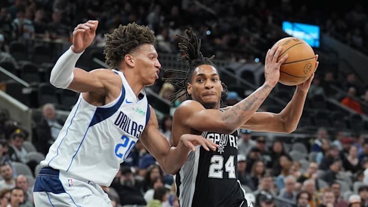 Mar 10, 2025; San Antonio, Texas, USA;  San Antonio Spurs guard Devin Vassell (24) drives in against Dallas Mavericks forward Kessler Edwards (20) in the first half at Frost Bank Center. Mandatory Credit: Daniel Dunn-Imagn Images