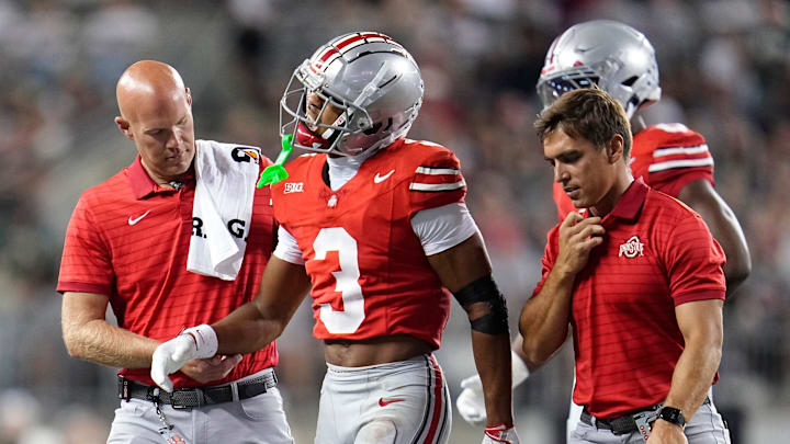 Ohio State Buckeyes cornerback Lorenzo Styles Jr. (3) is helped off the field by trainers during the second half of the NCAA football game against the Ohio Bobcats at Ohio Stadium on Sept. 13, 2025. Ohio State won 37-9.