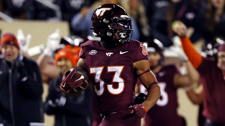 Nov 30, 2024; Blacksburg, Virginia, USA; Virginia Tech Hokies running back Bhayshul Tuten (33) runs the ball for a touchdown during the fourth quarter against the Virginia Cavaliers at Lane Stadium. Mandatory Credit: Peter Casey-Imagn Images